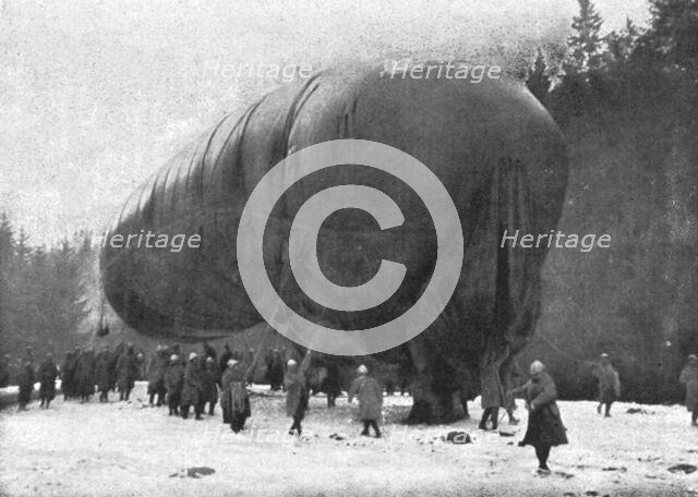 'La "Saucisse"; Avant l'ascension : "-- Sous son ventre ride de gros saurien, pend son…."', 1916. Creator: Unknown.
