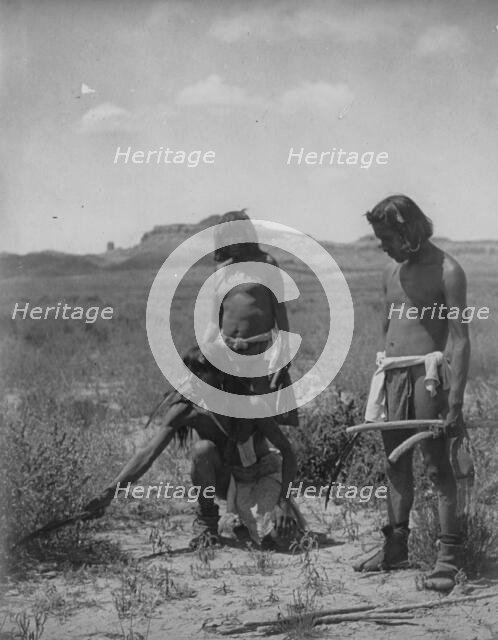 Me Sa Tawa catching snakes-Hopi, c1907. Creator: Edward Sheriff Curtis.
