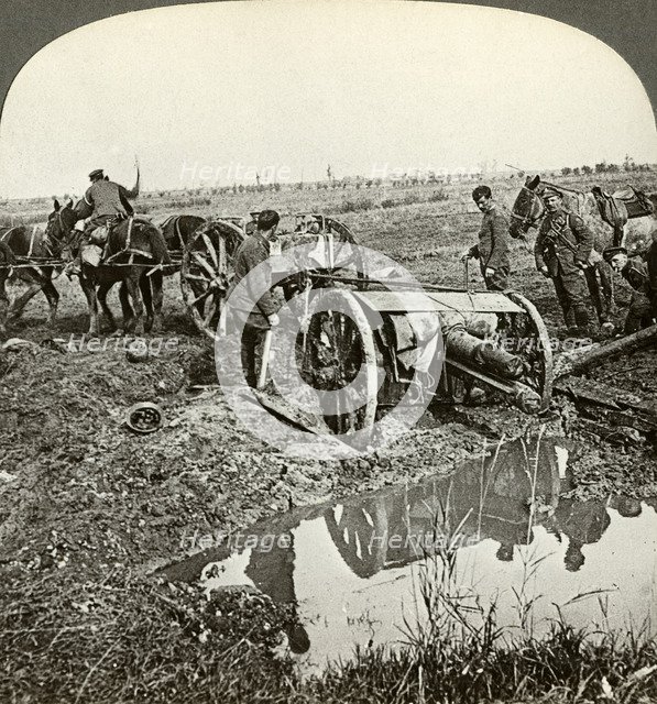 Removing a field gun from a flooded position, World War I, 1914-1918.Artist: Realistic Travels Publishers