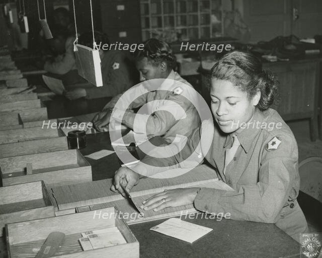 Members of the Women's Army Corps identifying incorrectly addressed mail for soldiers..., 1943. Creator: Unknown.