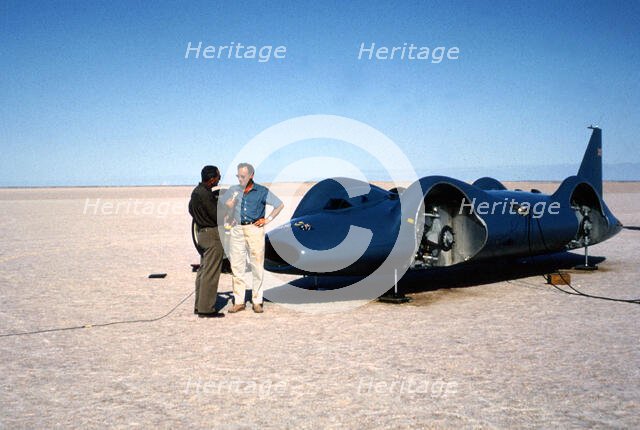 Donald Campbell being interviewed in front of Bluebird CN7, Lake Eyre, Australia, 1964. Creator: Unknown.