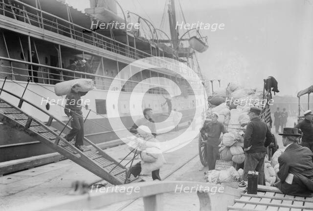 Taking Luggage off "Solace", 1914. Creator: Bain News Service.