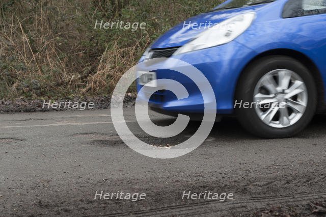 Pot holes in road surface 2017. Creator: Unknown.