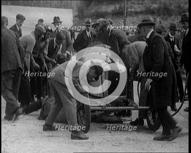 A Group of Male Civilians Working on a Car, 1924. Creator: British Pathe Ltd.