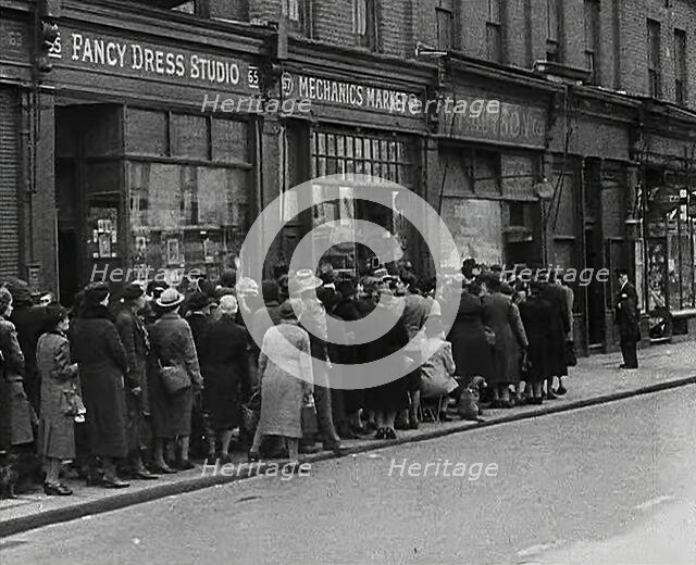 Civilians Queueing Outside a Food Shop, 1942. Creator: British Pathe Ltd.