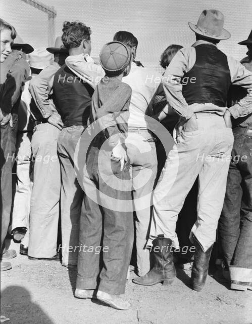 Watching ball game, Shafter migrant camp, California, 1938. Creator: Dorothea Lange.