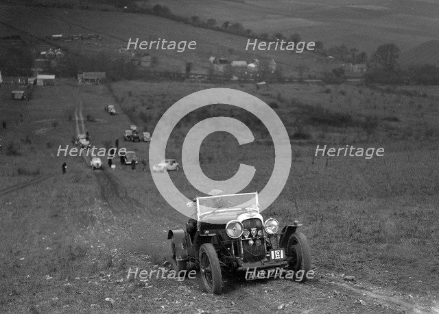 Lagonda Rapier competing in the London Motor Club Coventry Cup Trial, Knatts Hill, Kent, 1938. Artist: Bill Brunell.