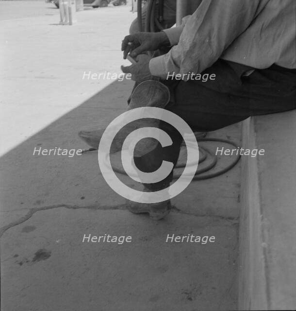 A Texas cattleman is distinguished by the type of boot he wears, Van Horn, Texas, 1937. Creator: Dorothea Lange.