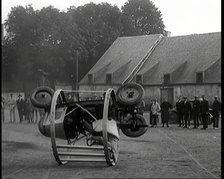 A Crashable Car With a Circular Frame Allowing It To Roll Over Being Tested in Front of..., 1926. Creator: British Pathe Ltd.