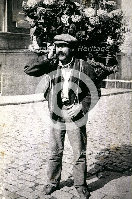 Typical picture of a street vendor of flowers, 1910.