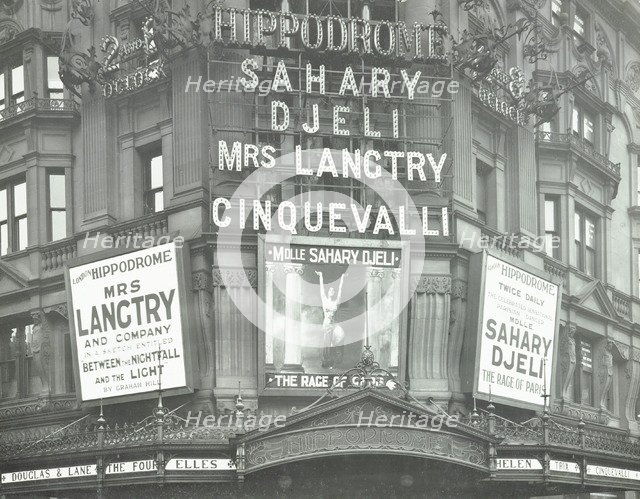 Illuminated advertisements on the front of The Hippodrome, Charing Cross Road, London, 1911. Artist: Unknown.