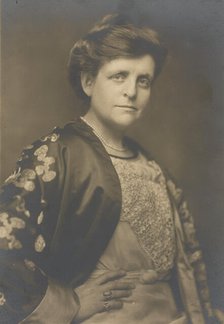 Frances Benjamin Johnston, half-length portrait, turned to the right, facing front, with..., 1911. Creator: William H Towles.