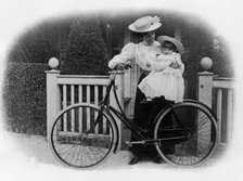 Beeston Humber cycle, Mrs. Hicks with child. Creator: Unknown.