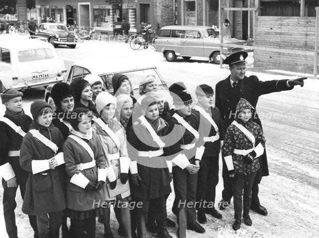 A policeman teaches a group of schoolchildren how to be traffic officers, Sweden, c1956-1969(?). Artist: Unknown