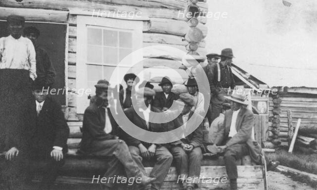 Indigenous peoples outside of log building, between c1900 and 1916. Creator: Unknown.