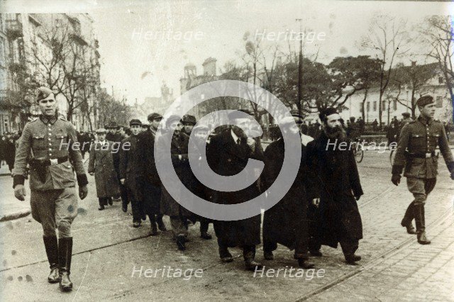 Polish Jews being escorted by German soldiers and Gestapo, Poland, March 1940. Artist: Unknown