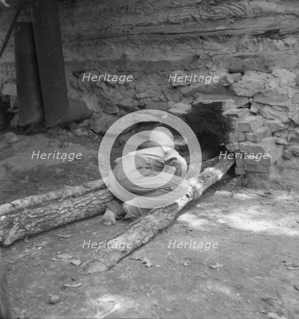 Ten year old son of tobacco tenant tends the fire..., Granville County, North Carolina, 1939. Creator: Dorothea Lange.