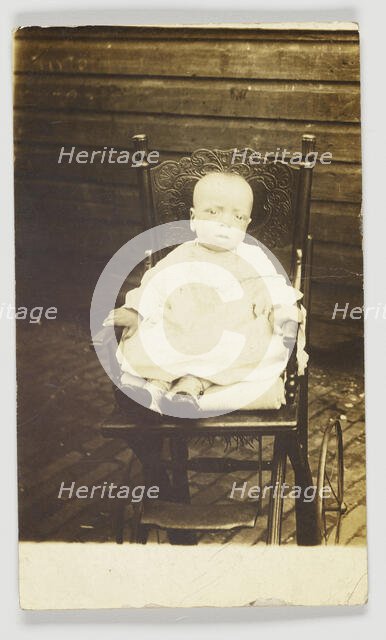 Photographic postcard of a baby in a stroller, 1918-1930. Creator: Unknown.