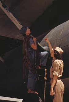 Mrs. Cora Ann Bowen (left) works as a cowler at the Naval Air Base..., Corpus Christi, Texas, 1942. Creator: Howard Hollem.
