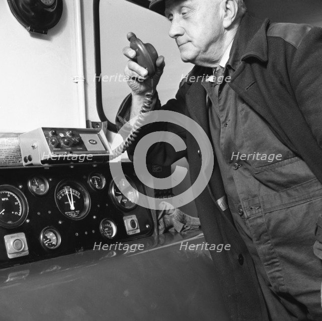 Train driver on an intercom, South Yorkshire, 1964. Artist: Michael Walters