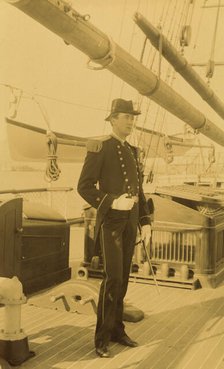 Unidentified naval officer, full-length portrait, standing aboard ship, facing right, 1894 or 1895. Creator: Alfred Lee Broadbent.