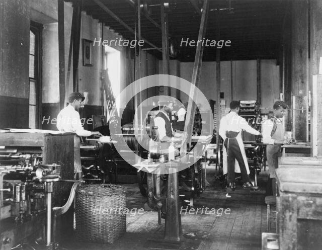 Pressmen at work in printing shop, Hampton Institute, Hampton, Virginia, 1899 or1900. Creator: Frances Benjamin Johnston.