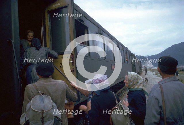 Local people boarding a train in Czechslovakia. Artist: CM Dixon Artist: Unknown