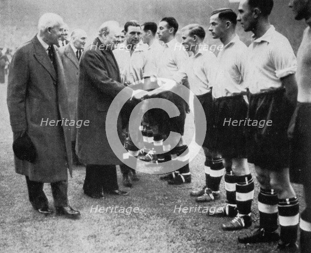 Winston Churchill greets the England football team, Wembley, London, October 1941.Artist: London News Agency