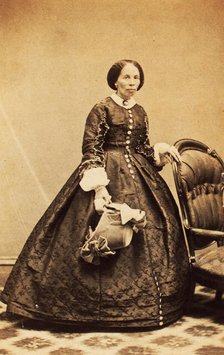 Portrait of older woman, standing, holding bonnet, c1860. Creator: CK Bill.