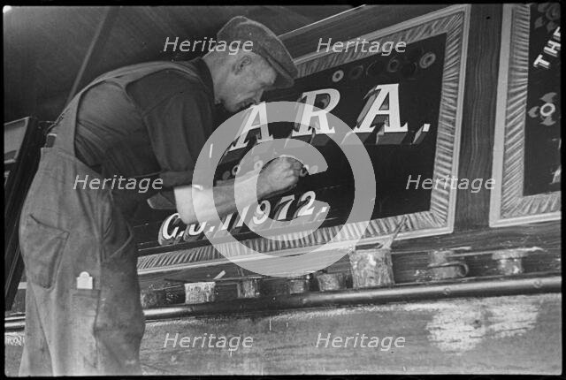 Barge painter Frank Jones, of 3 Edward Street, at work, Leighton Buzzard, Bedfordshire, 1910-60. Creator: George R Long.
