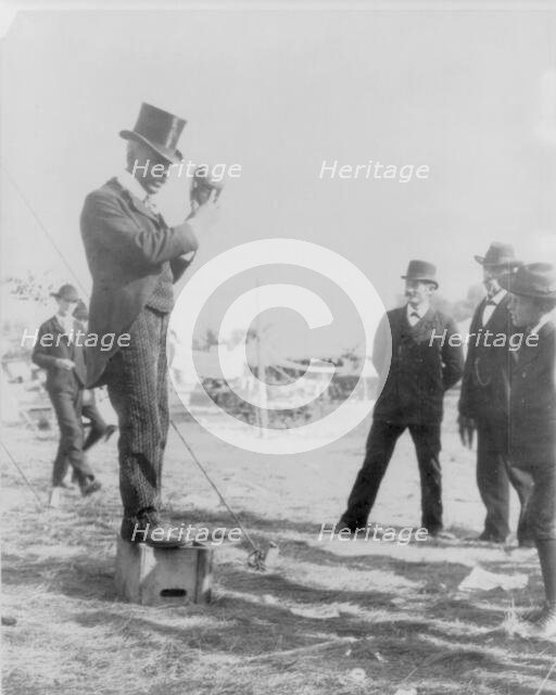 Minnesota State Fair: African American on soap box using hand puppet, 1900?. Creator: Unknown.