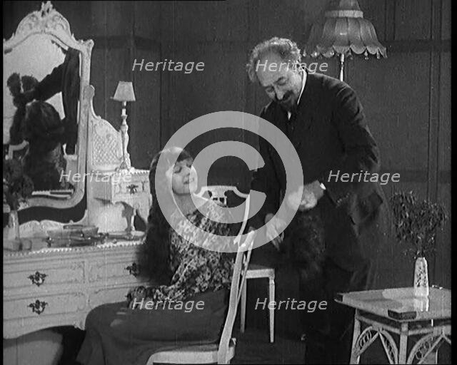 Female Civilian Having Her Hair Cut Into a 'Shingle' by a Male Civilian Hairdresser, 1920. Creator: British Pathe Ltd.