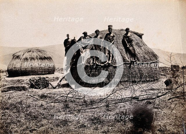 Africa: a group of African people standing on a kraal hut, between 1800 and 1899. Creator: Unknown.