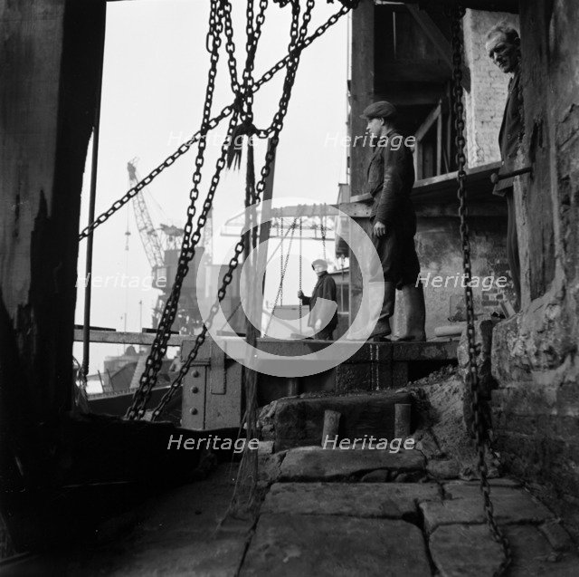 Men working at a wharf on the River Thames in Limehouse, London, c1945-c1965. Artist: SW Rawlings