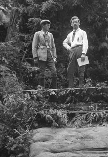 Sterling, George, and Porter Garnett, standing...at the Bohemian Grove, Sonoma, Ca., c1906-1911. Creator: Arnold Genthe.
