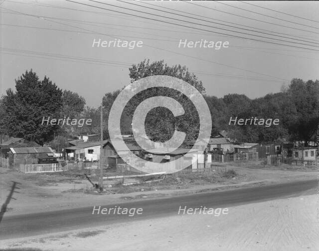 Winter migrant camp on the outskirts of Sacramento, California, 1936. Creator: Dorothea Lange.