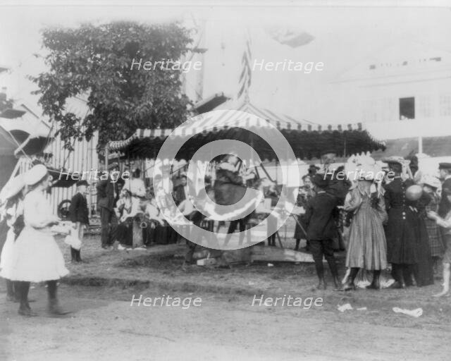 Minnesota State Fair: children on small merry-go-round, 1900?. Creator: Unknown.