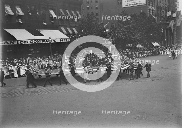 Preparedness Parade - Men Carrying Huge Flag, 1916. Creator: Harris & Ewing.