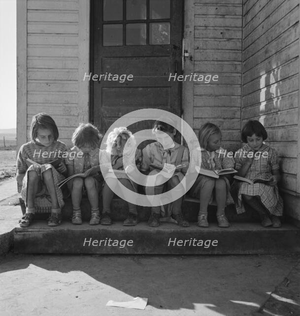 Girls of Lincoln Bench School study their reading lesson, near Ontario, Malheur County, Oregon, 1939 Creator: Dorothea Lange.