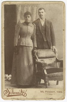 Photograph of an African-American couple standing behind a chair, ca. 1890. Creator: Schmitz Studio.