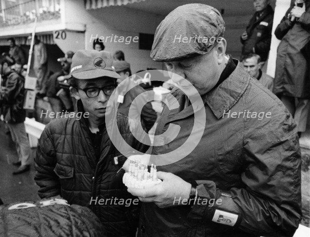 Honda technicians selecting the appropriate plugs. Artist: Unknown