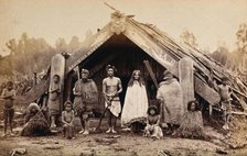 New Zealand: a group of Maori in front of a traditional building, 19th century. Creator: Unknown.
