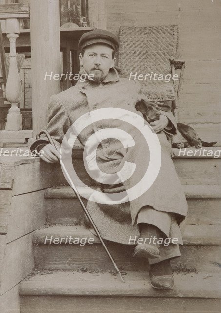 Anton Chekhov (1860-1904) with dog Hina. Melikhovo, 1897.