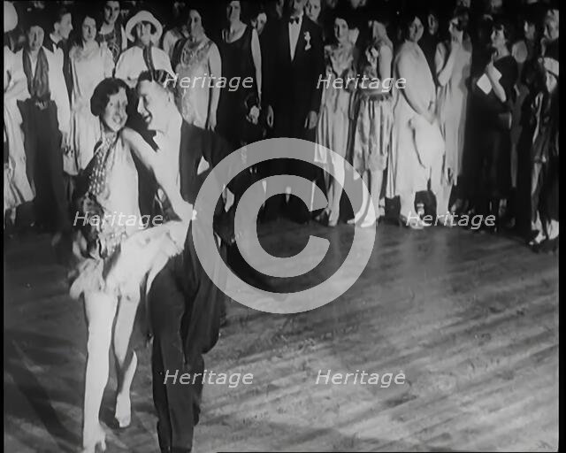 Female Civilian and Male Civilian Dancing in Front of a Crowd of People, 1926. Creator: British Pathe Ltd.