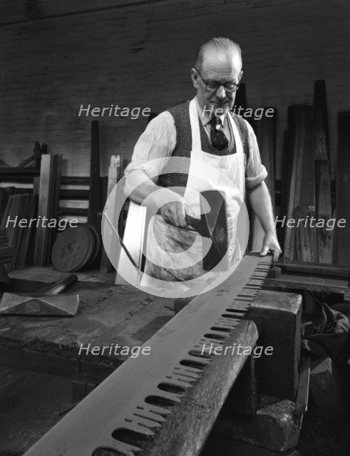 Tensioning the crosscut on a two metre saw blade, Sheffield, South Yorkshire, 1963. Artist: Michael Walters