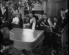 Pianist Playing the Piano and Singing "Stormy Weather", 1936.  Creator: British Pathe Ltd.