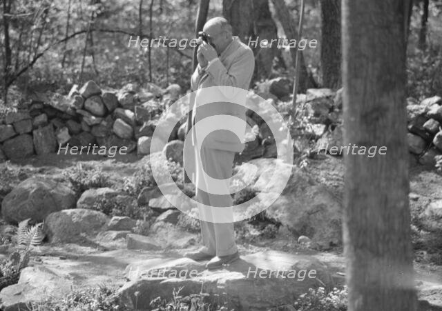 Rothbart, Albert, Mr., taking a photograph outdoors, between 1920 and 1935. Creator: Arnold Genthe.