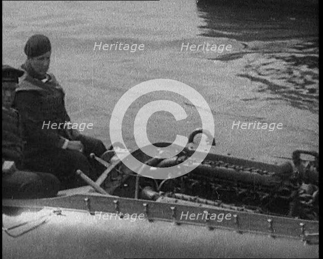 Marion Barbara 'Joe' Carstairs on a Speedboat with a Male Civilian Passenger, 1920. Creator: British Pathe Ltd.