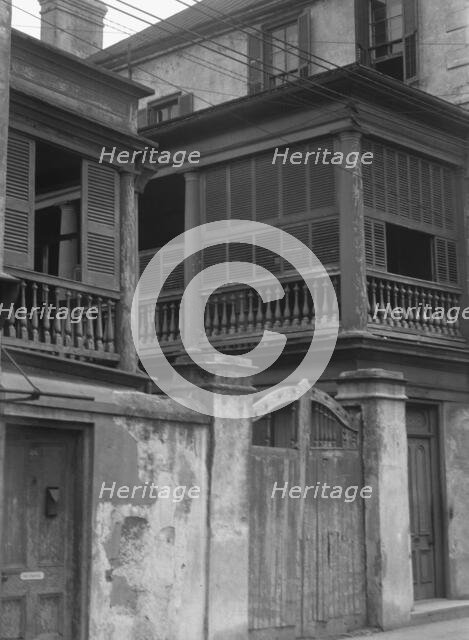 Multi-story house behind wall with gate, Charleston, South Carolina, between 1920 and 1926. Creator: Arnold Genthe.