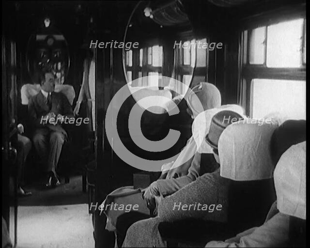 Female Civilian Wearing a Dress and Hat Modelling in Front of a Small Audience Inside a..., 1920. Creator: British Pathe Ltd.